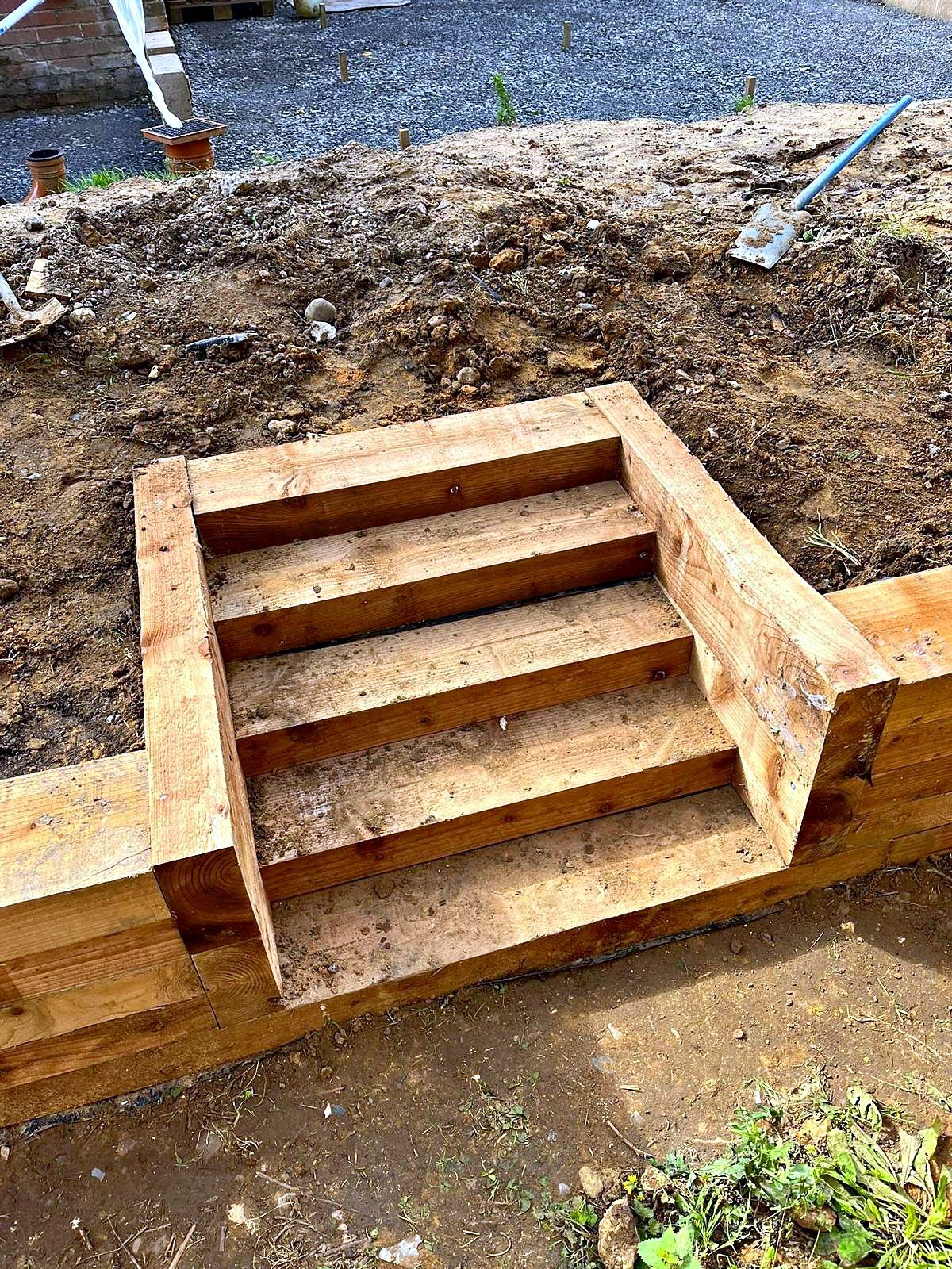 Solid timber sleeper steps built into a sloping garden bank