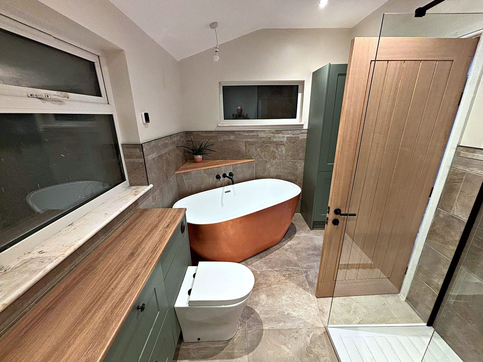 Bathroom with copper freestanding bath, sage vanity unit, oak worktop and a walk-in shower